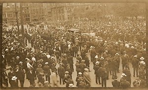 a large crowd of people standing in the street in 1919 in Winnipeg