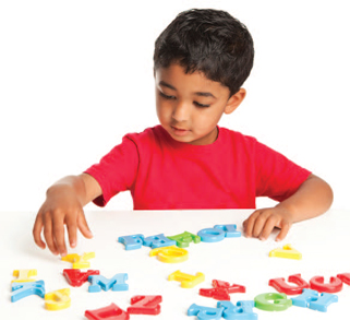 child playing with letters at a table