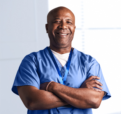 Healthcare professional crossing his arms and smiling