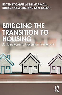Book cover for Bridging the Transition to Housing: A Homelessness Prevention Framework. The cover shows a row of three simple, illustrated house shapes in muted pastel colours, aligned on a ledge in the foreground.