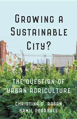 Book cover for Growing a Sustainable City. The cover shows an urban garden with rows of green plants in the foreground and buildings and utility poles in the background under a pale blue sky.