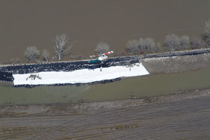 Helicopters deliver sandbags to Assiniboine River dike reinforcement. May 2011 Helicopters deliver sandbags to Assiniboine River dike reinforcement. May 2011